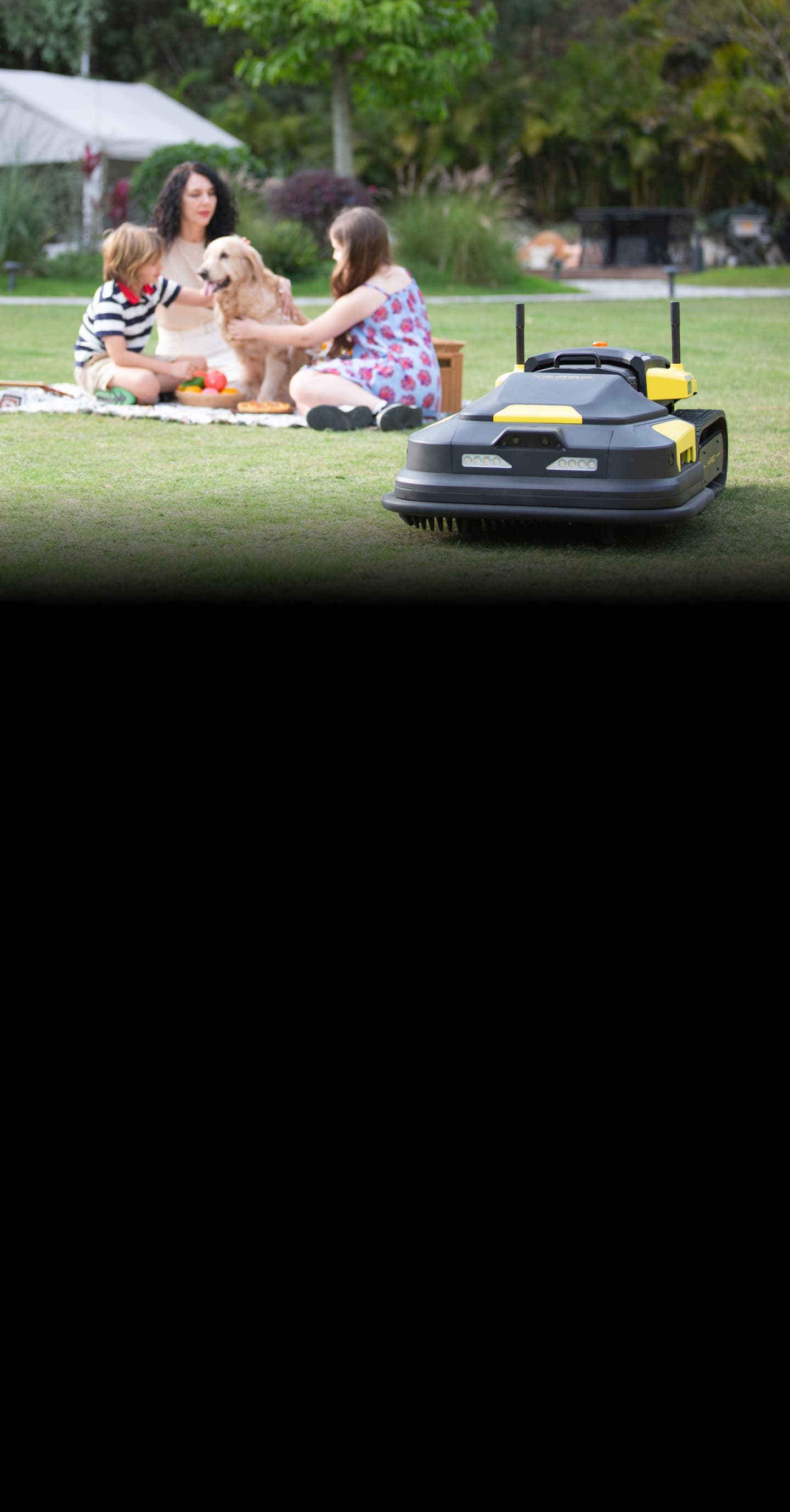 Yarbo lawn mower working while a family is spending time together in a lawn