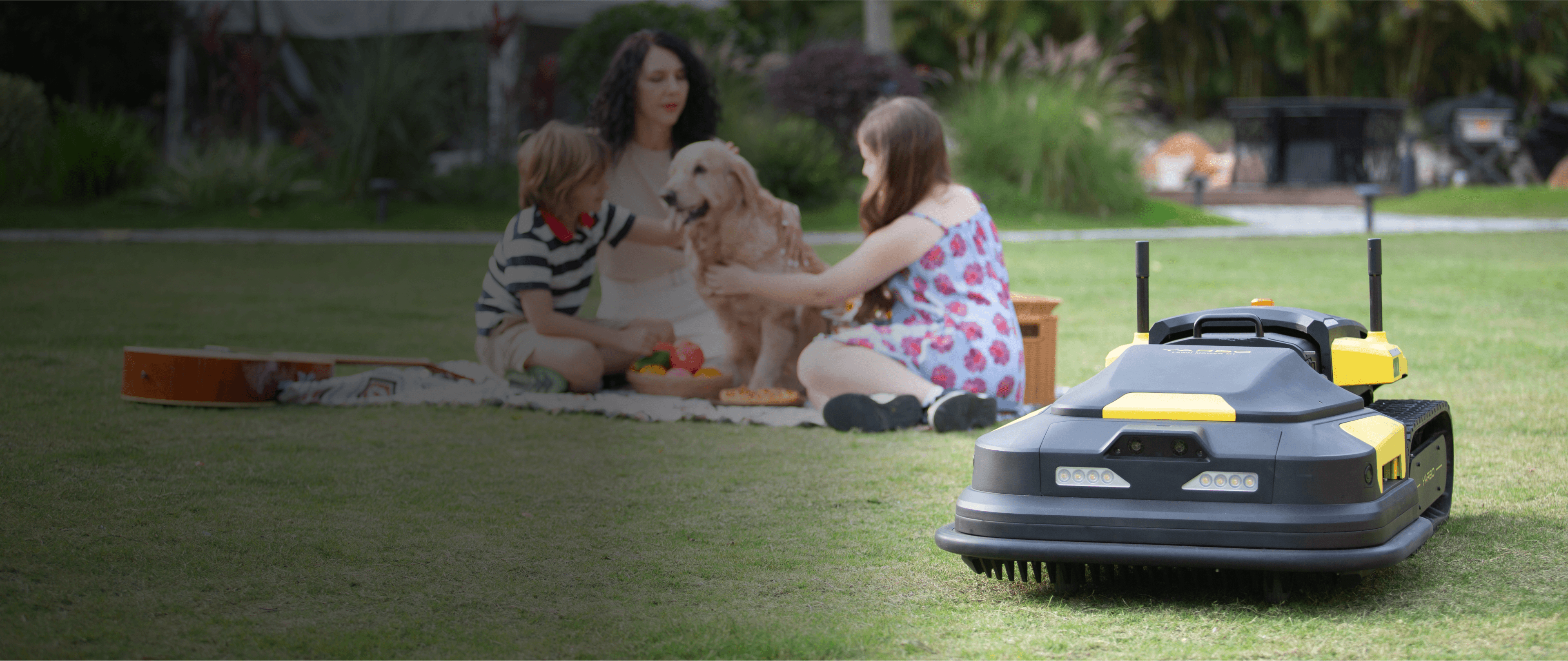 Yarbo lawn mower working while a family is spending time together in a lawn